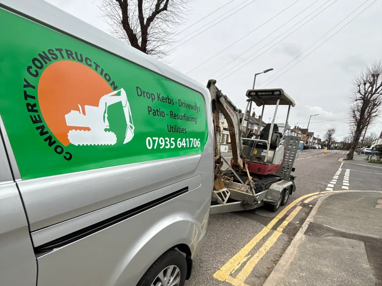Connerty Construction van and Takeuchi mini excavator on trailer, parked on a Maidstone street